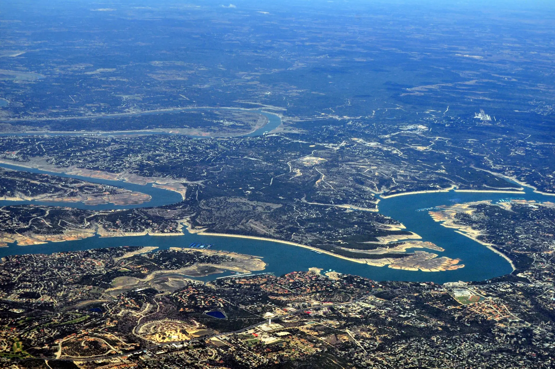 Aerial view of Lake Travis winding through the limestone hills west of Austin