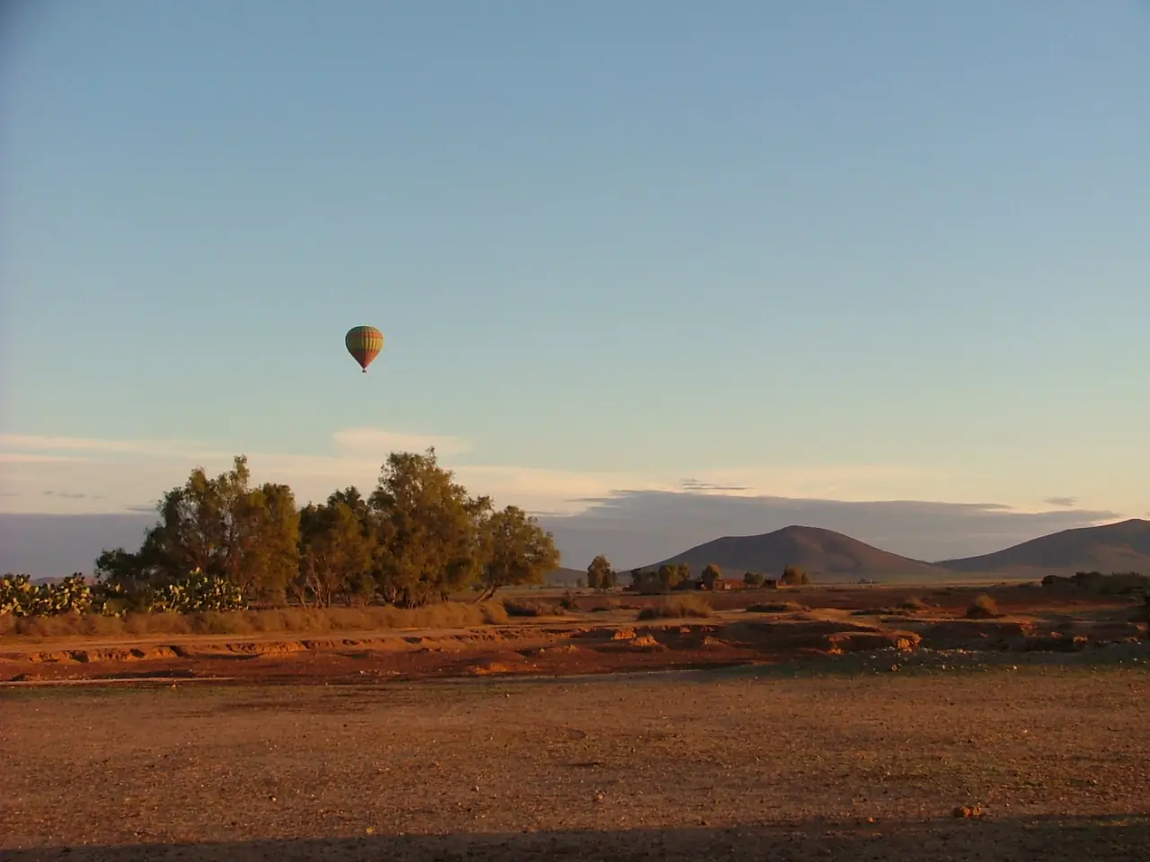 A balloon basket and envelope being prepared at dawn near Marrakech