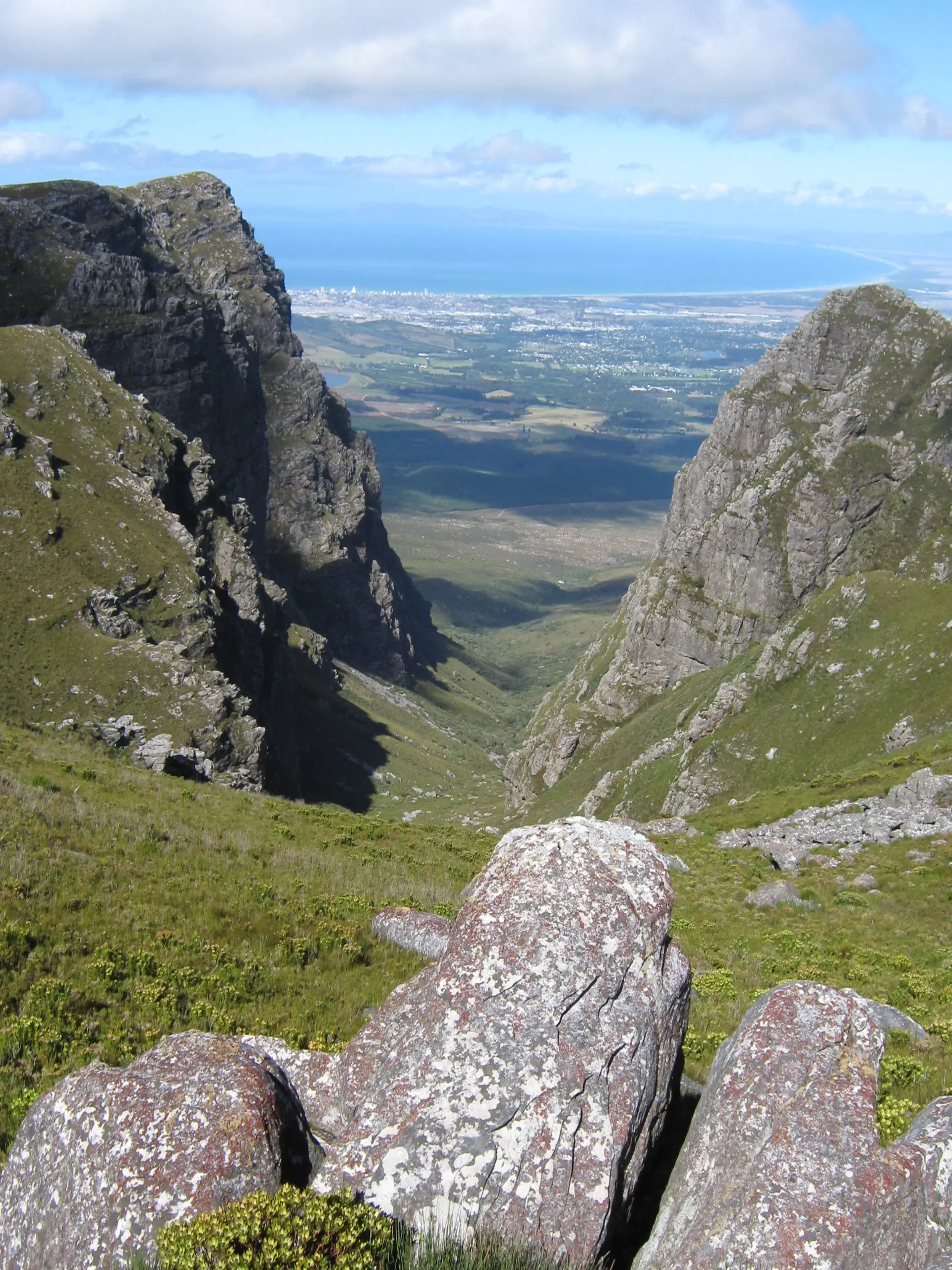 A steep rocky kloof in the Hottentots Holland Nature Reserve with the valley opening out below