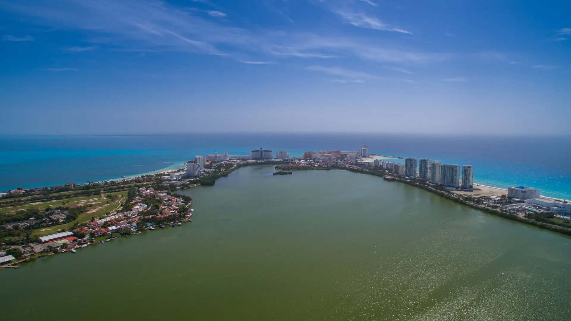 Cancún's hotel zone from the air, a thin strip between the Nichupté lagoon and the Caribbean