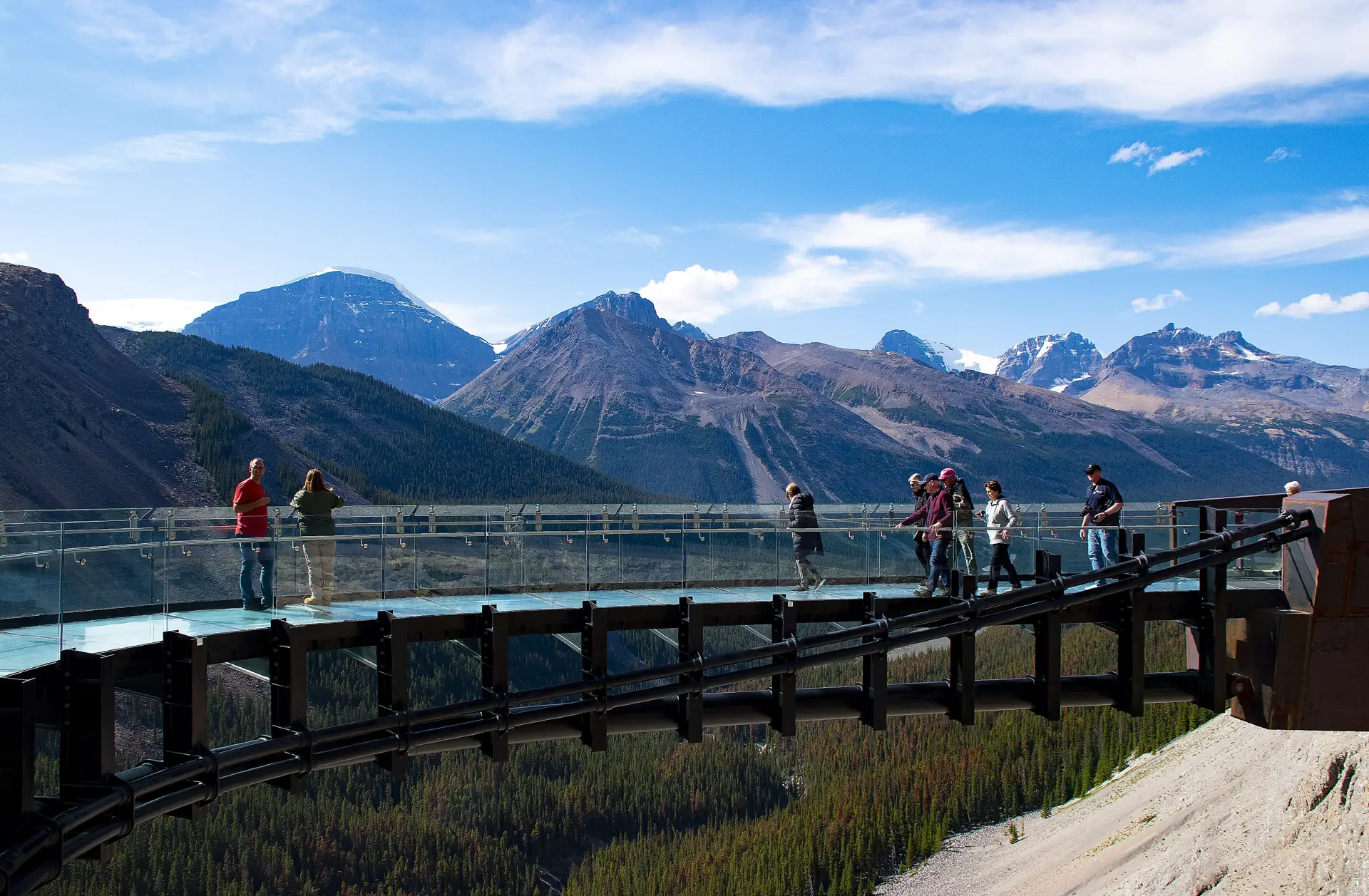 Visitors on the curved glass floor of the Columbia Icefield Skywalk high above the Sunwapta Valley