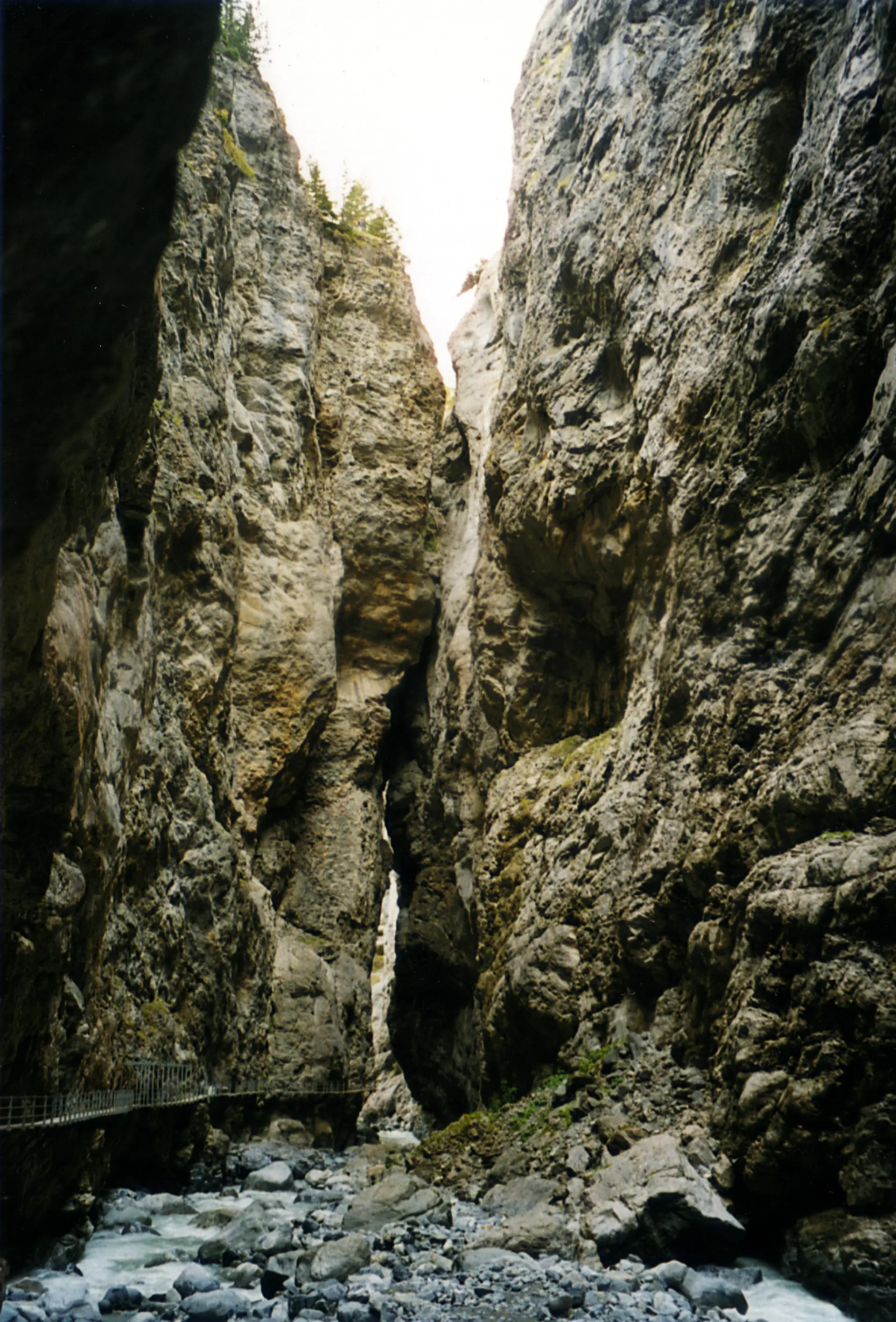 The narrow Gletscherschlucht glacier gorge at Grindelwald, sheer rock walls with the river far below the walkway