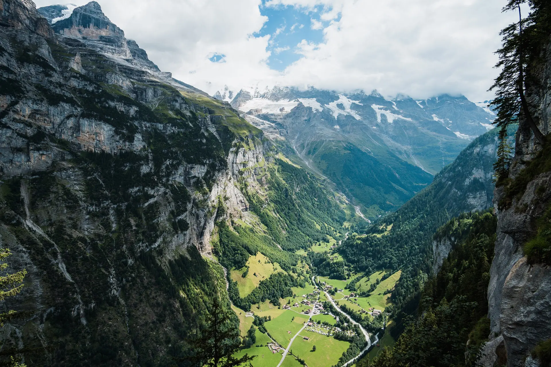 The Lauterbrunnen valley seen from the cliff edge at Mürren, with the valley floor far below and the peaks across