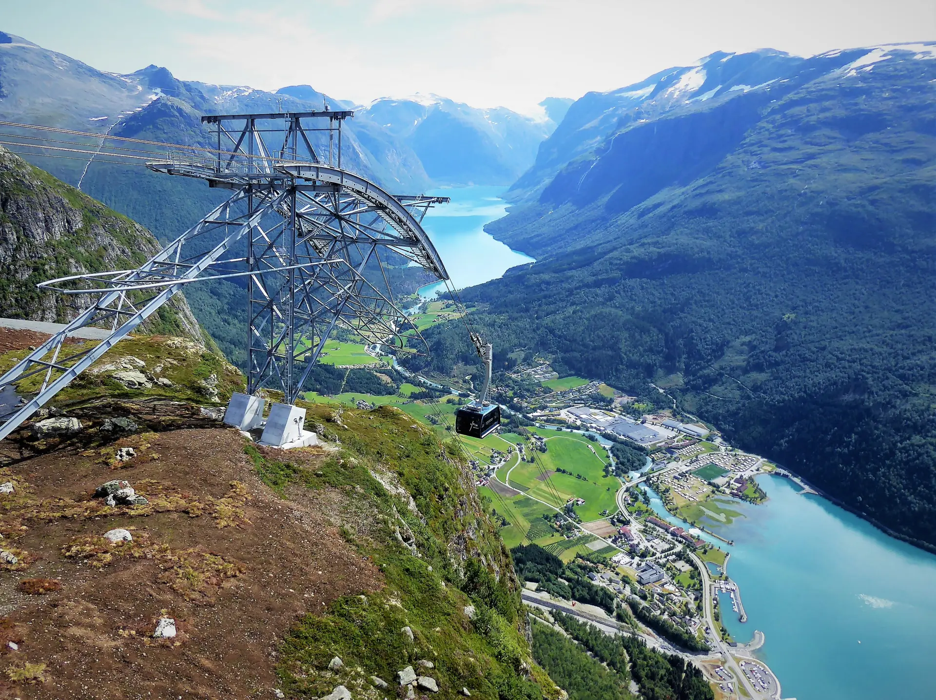 A Loen Skylift cabin hanging from the cable high above the Nordfjord, the fjord and green valley floor far below
