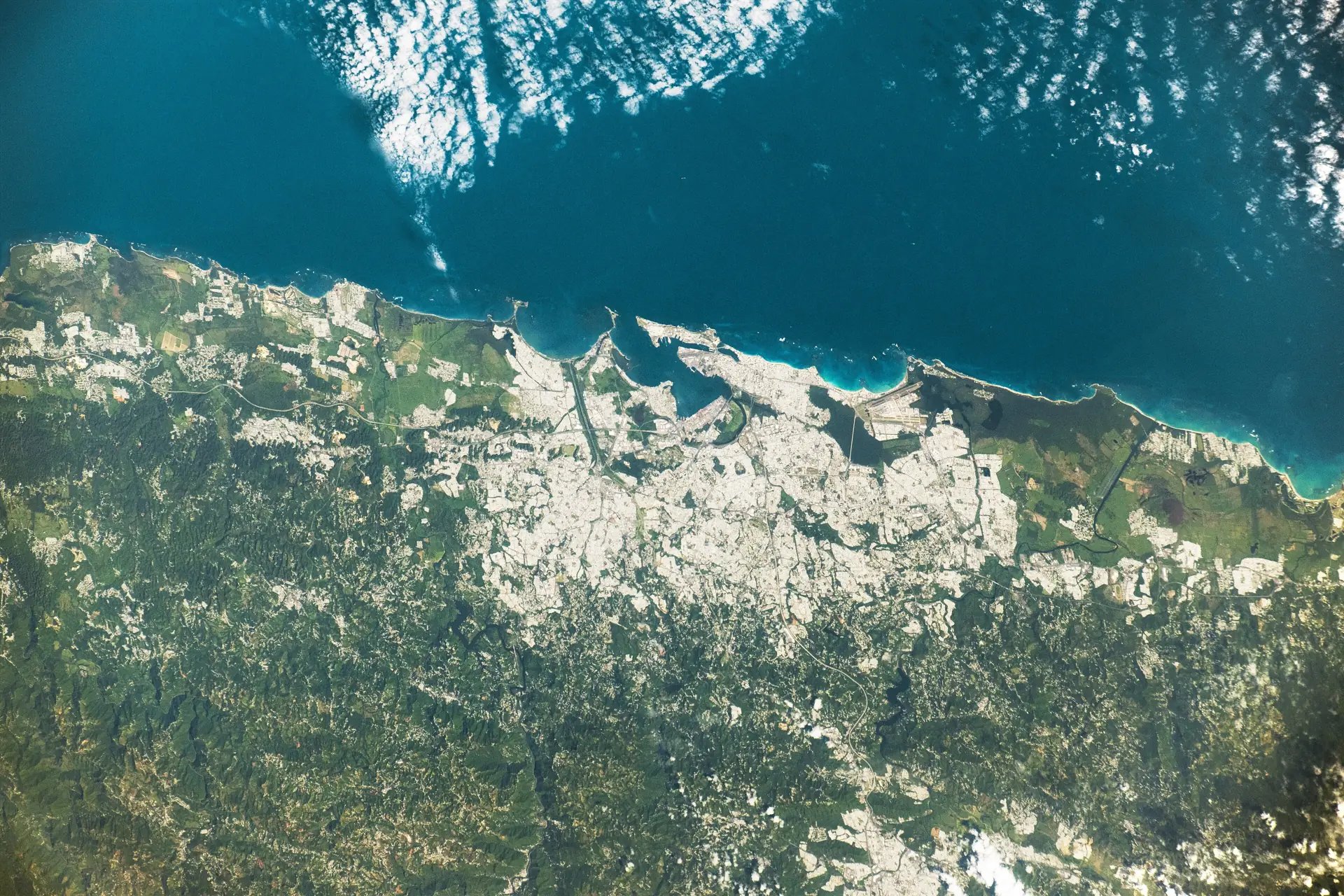 The north coast of Puerto Rico around Arecibo seen from above, karst hills meeting the Atlantic