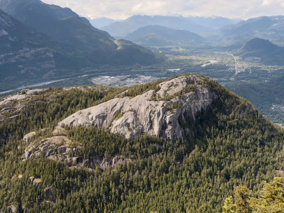 Looking down on the granite dome of the Stawamus Chief from the Sea to Sky Gondola, with Squamish and Howe Sound behind