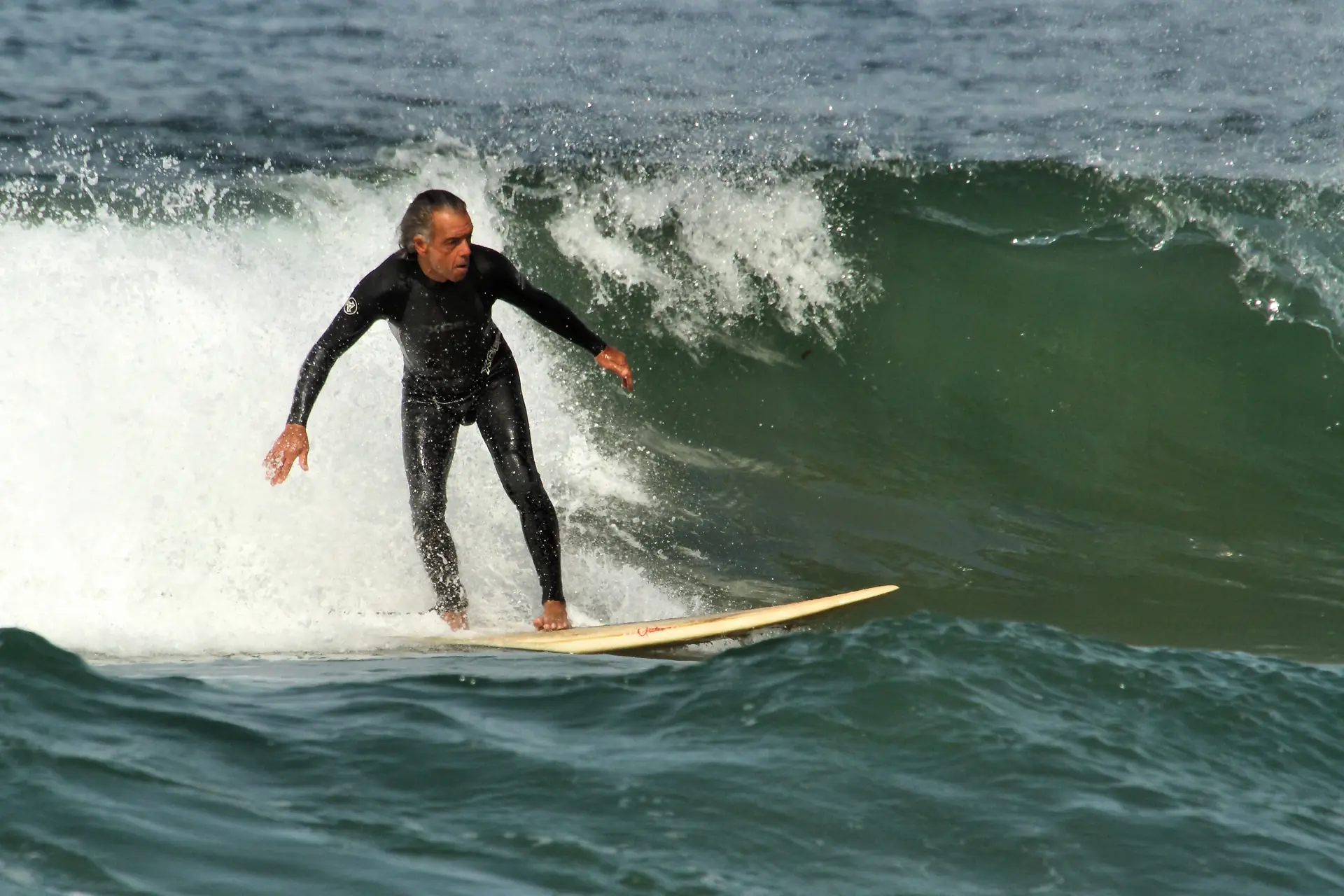 A surfer riding a wave off Santa Monica