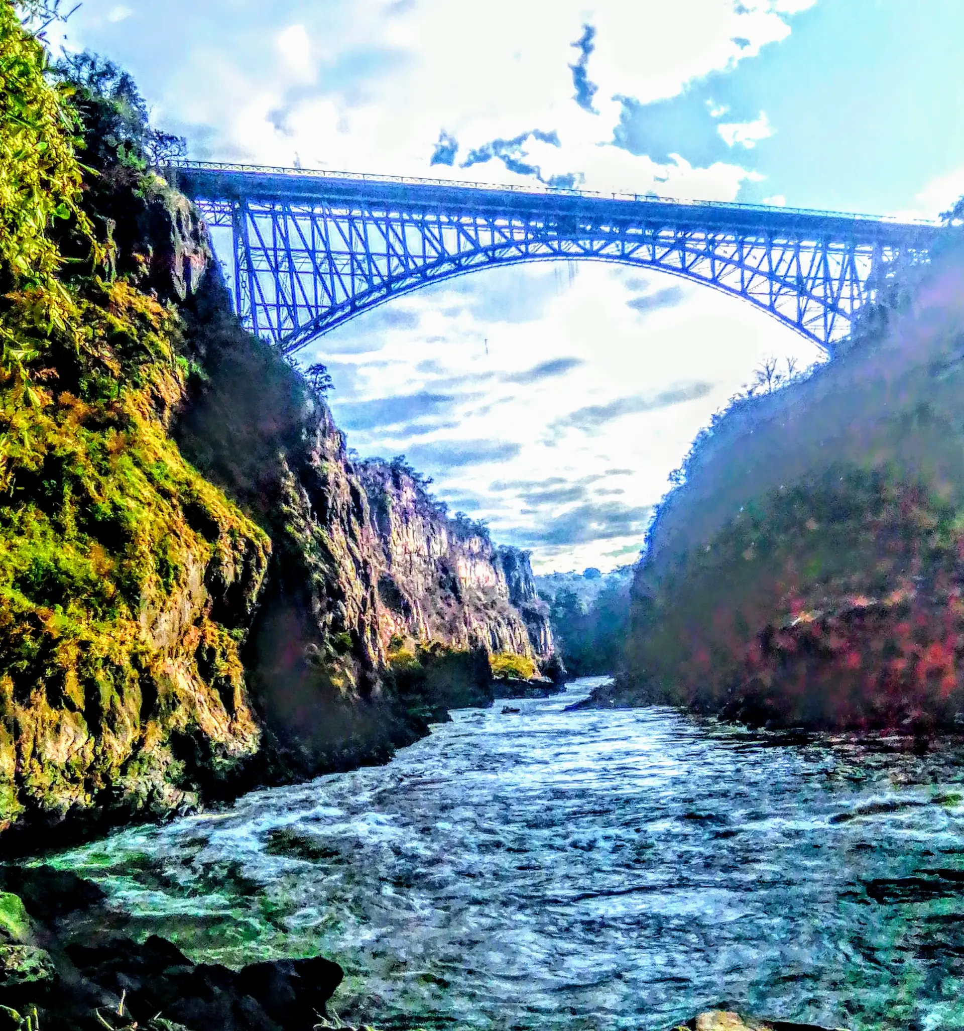 The Zambezi in the First Gorge below Victoria Falls Bridge, with the steel arch spanning the basalt walls