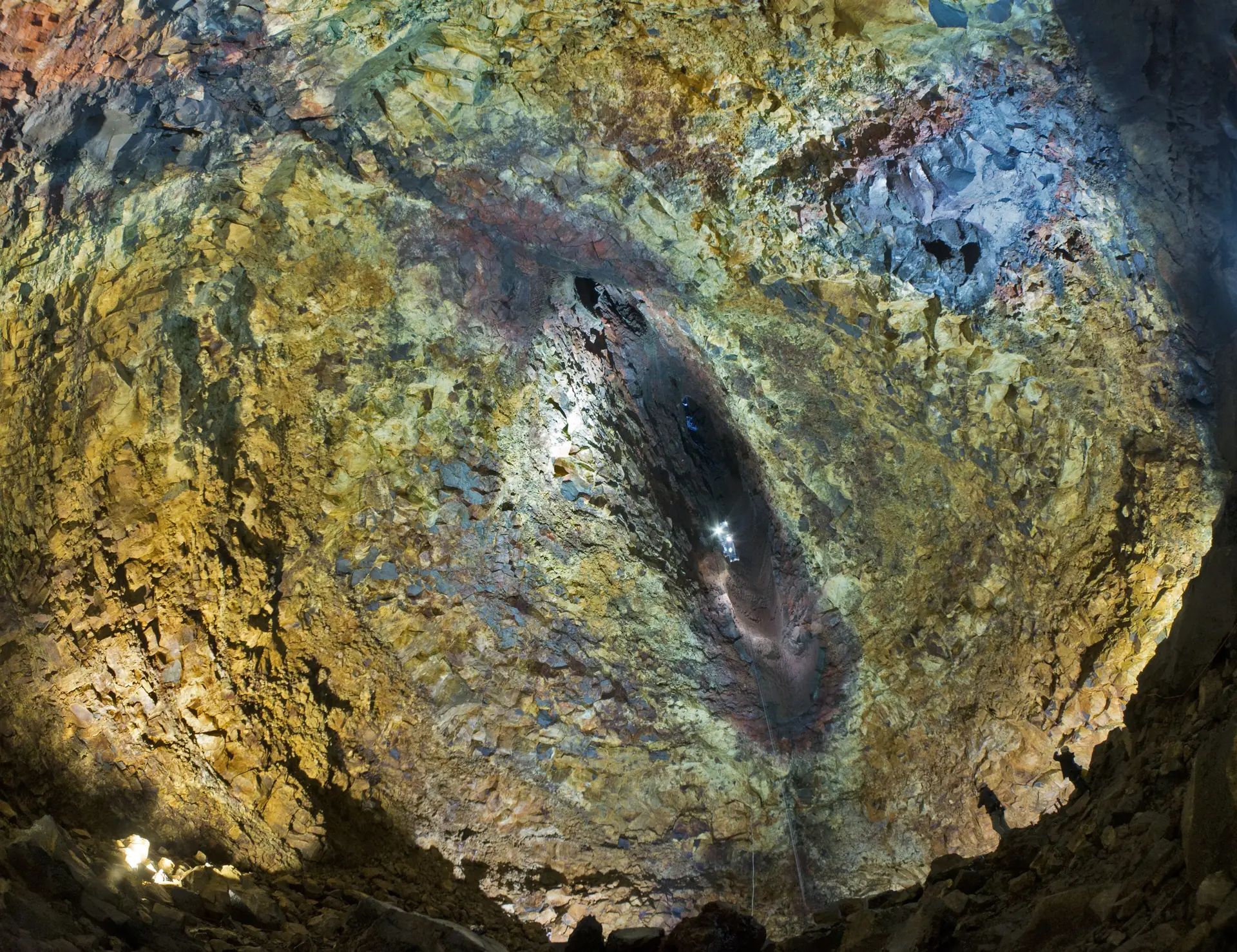 The coloured rock walls inside the Þríhnúkagígur magma chamber, lit from above